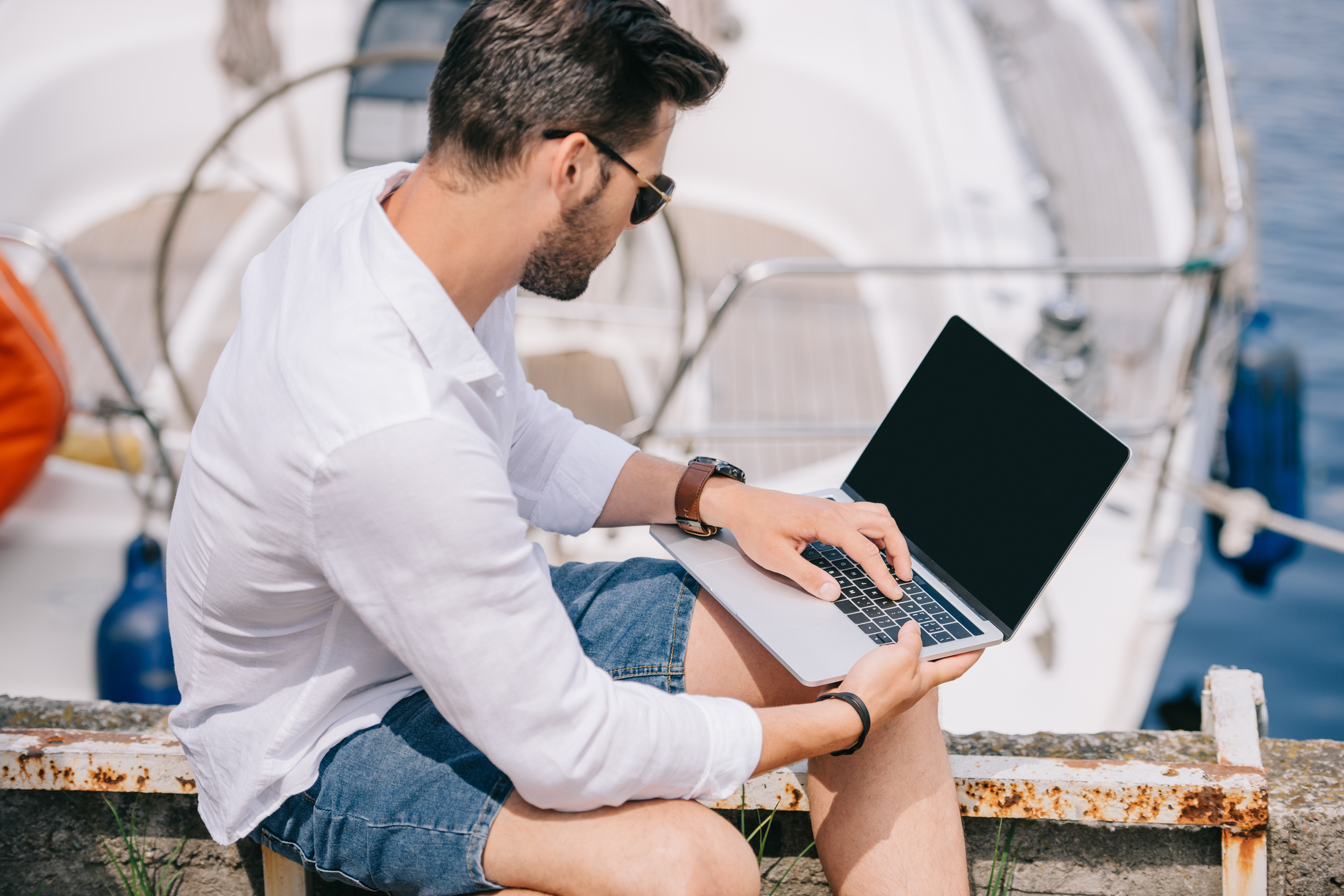 guy on laptop on boat